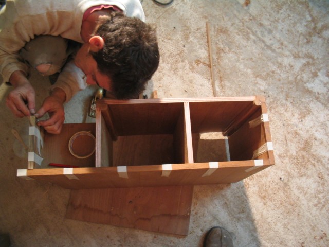 Flicka companionway box trim being glued on