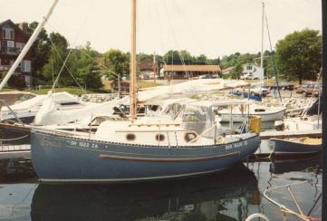 BEN MAIN, JR’s. dodger / bimini / side curtain enclosure adds a considerable amount of living space. The grey sunbrella matches the hull of this classic little yacht.