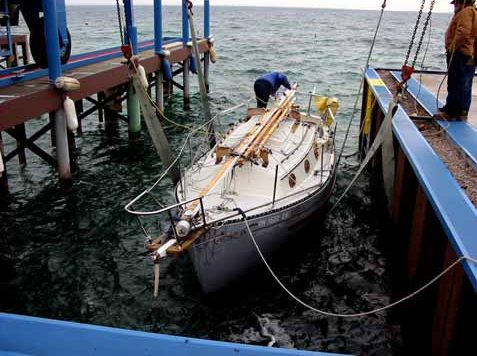 The marina crew was ready with properly adjusted slings to catch the Flicka, almost eliminating the need for dock lines