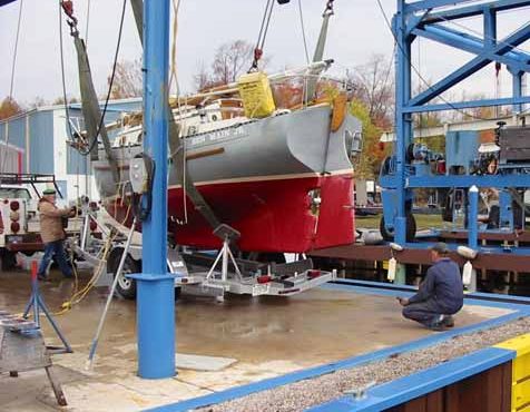 The boatyard crew quickly went to work adjusting the trailer to fit the Flicka. Their pace was slow enough to eliminate any mistakes