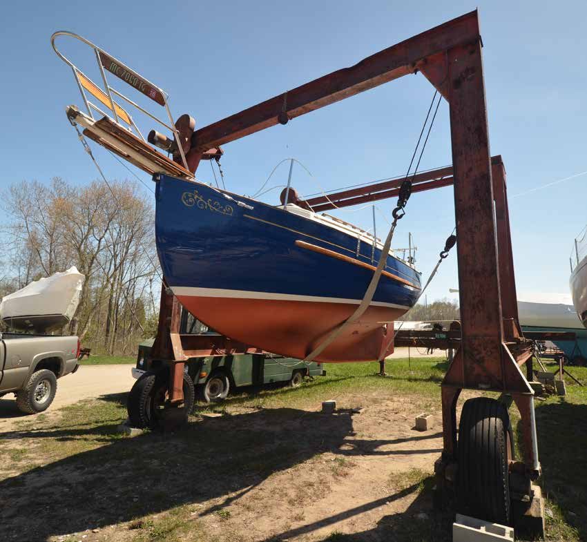 Waiting for her modified Jowi boat cradle, s/y ZANZIBAR hangs from a travel-lift. Note the brand new bottom paint!